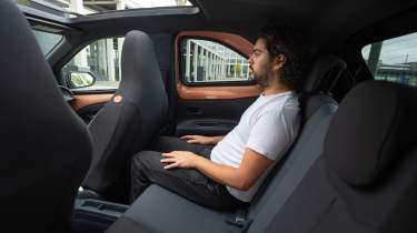 Toyota Aygo X Hybrid - rear interior, car being sat in by Auto Express senior staff writer Jordan Katsianis